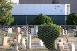 One of 3 refrigerated trailers, sent by FEMA to help with the rising number of COVID-19 fatalities, are seen parked at the rear of the El Paso County Office of the Medical Examiner, in El Paso, Texas, Nov. 9, 2020.