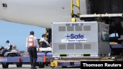Workers unload AstraZeneca vaccine shipped from Japan in Taoyuan, July 8, 2021.