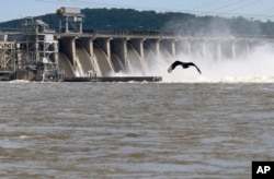 Water flows through Conowingo Dam, a hydroelectric dam spanning the lower Susquehanna River near Conowingo, Md., on Thursday, May 16, 2019. (AP Photo/Steve Ruark)