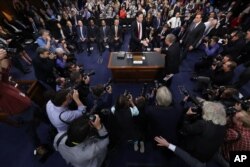 Former FBI director James Comey is greeted by Senate Intelligence Committee Chairman Richard Burr, R-N.C. at the beginning of the Senate Intelligence Committee hearing on Capitol Hill, June 8, 2017, in Washington.