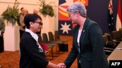 Australia's Foreign Minister Penny Wong, right, greets Indonesia's Foreign Minister Retno Marsudi during the Australia-ASEAN summit in Melbourne on March 4, 2024. 