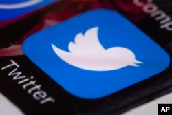 FILE - The Twitter app is seen on a mobile phone in Philadelphia, April 26, 2017.