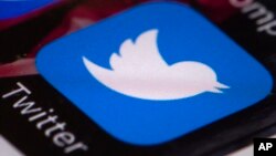 FILE - The Twitter app is seen on a mobile phone in Philadelphia, April 26, 2017.