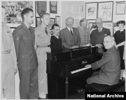 President Truman playing the piano in the White House