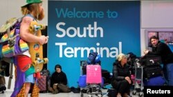 Passengers wait in the South Terminal building at Gatwick Airport, after the airport reopened to flights following its forced closure because of drone activity, in Gatwick, Britain, Dec. 21, 2018. 