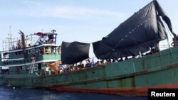 A Kashmiri man removes snow from a hotel premise in Gulmarg, about 55 kilometers (34 miles) northwest of Srinagar, Indian-controlled Kashmir. Authorities have issued avalanche warnings for many parts of the region, as the heavy snowfall has cut off roads, disrupted power and communication lines, and forced the evacuation of hundreds of residents.