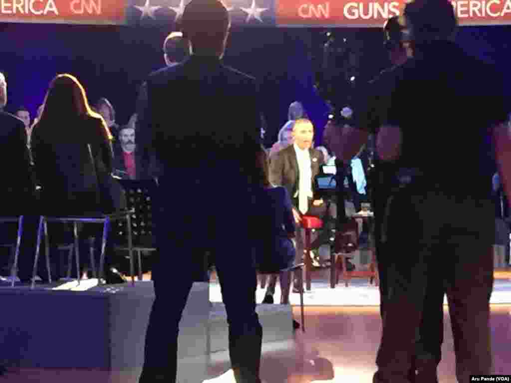 President Barack Obama can be seen through attendees of a CNN televised town hall meeting hosted by Anderson Cooper, not shown, at George Mason University in Fairfax, Va., Jan. 7, 2016.