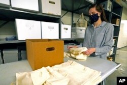 Jessica Walzer, archaeology collections manager with the Mississippi Department of Archives and History, gathers unprovenanced prehistoric pottery and lithics on, Friday, March 19, 2021, outside the Two Museums' Archaeology Collections Storage room in Jackson, Miss.