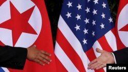 FILE - U.S. President Donald Trump and North Korea's leader Kim Jong Un meet at the start of their summit at the Capella Hotel on the resort island of Sentosa, Singapore, June 12, 2018.
