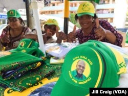 Vendors in Dar es Salaam near the CCM headquarters building promote their party's candidate, John Magufuli on Oct. 22, 2015. (Photo: Jill Craig / VOA)