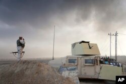 Smoke rises from Islamic state positions after an airstrike by coalition forces in Mosul, Iraq, Oct. 18, 2016.