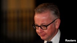Britain's Environment Secretary, Michael Gove, leaves 10 Downing Street, in London, Nov. 14, 2018.