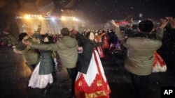 North Koreans dance on the Kim Il Sung Square to celebrate a satellite launch, Feb. 8, 2016, in Pyongyang, North Korea. (AP Photo/Jon Chol Jin)