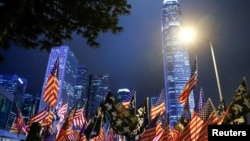 FILE - Protesters hold U.S. flags during a gathering at Edinburgh Place in Hong Kong, China, Nov. 28, 2019. 