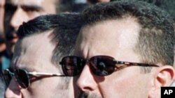 Bashar al-Assad (R) and his younger brother Maher al-Assad, (File)