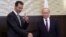 FILE - Russian President Vladimir Putin, right, shakes hands with Syrian President Bashar Assad in the Black Sea resort of Sochi, Russia, Nov. 20, 2017.