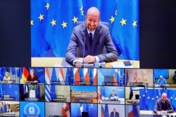 FILE - European Council President Charles Michel is seen on a screen as he speaks with EU leaders during an EU Summit video conference, amid the coronavirus disease (COVID-19) outbreak, at the European Council building in Brussels, Nov. 19, 2020.