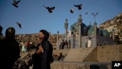 Women talk outside the Karti Sakhi Shrine in Kabul, Afghanistan, Oct. 23, 2021. A top official in Taliban-led Afghanistan assured, Nov. 23, 2021, female players they can continue playing cricket.