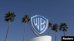 FILE - The Warner Bros. logo is seen during the annual MIPCOM television program market in Cannes, France, Oct. 14, 2019. 