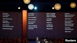 FILE - The names of the victims of Malaysian Airlines MH17 are screened during a national memorial at the RAI convention center in Amsterdam, The Netherlands, Nov. 10, 2014.