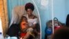 FILE - Ado Ntanga, 23, holds her son, Adrielle Nyembwe, 3, who was admitted to the Medicare Policlinic with Sickle Cell Anemia in Lubumbashi, Democratic Republic of the Congo.