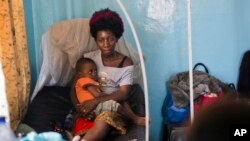 FILE - Ado Ntanga, 23, holds her son, Adrielle Nyembwe, 3, who was admitted to the Medicare Policlinic with Sickle Cell Anemia in Lubumbashi, Democratic Republic of the Congo.