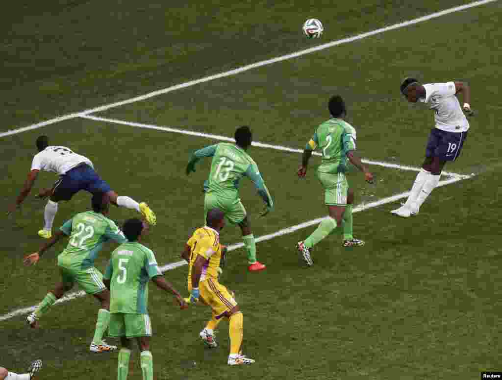 Paul Pogba, playing for France, heads the ball into the net at the national stadium in Brasilia, June 30, 2014.