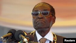 FILE - President Robert Mugabe waits to address crowds gathered for Zimbabwe's Heroes Day commemorations in Harare, August 10, 2015.
