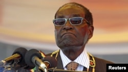 FILE: President Robert Mugabe waits to address crowds gathered for Zimbabwe's Heroes Day commemorations in Harare, August 10, 2015.