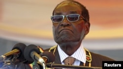 FILE: President Robert Mugabe waits to address crowds gathered for Zimbabwe's Heroes Day commemorations in Harare, August 10, 2015.