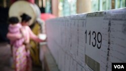 FILE: A Cambodian women is checking her name on the voter list at a polling station in Phnom Penh, Cambodia, June 2017. (Hean Socheata/VOA Khmer)