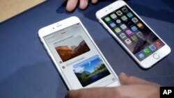 FILE - In this Tuesday, Sept. 9, 2014, file photo, the iPhone 6 plus, left, and iPhone 6 are displayed, in Cupertino, Calif. 