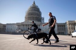 U.S. Capitol Police officers keep watch over the East Front of the Capitol as Congress prepares to return to work following the weekend terror attacks in Paris that killed 129 people, in Washington, Nov. 16, 2015.