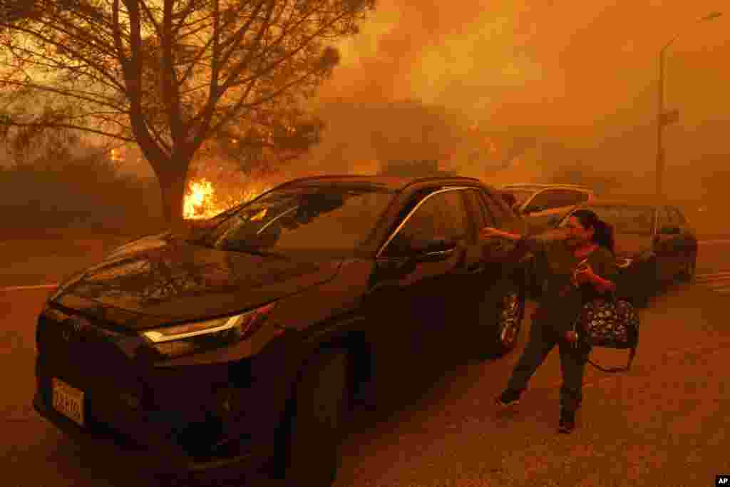 A woman cries as the Palisades Fire advances in the Pacific Palisades neighborhood of Los Angeles, Jan. 7, 2025.