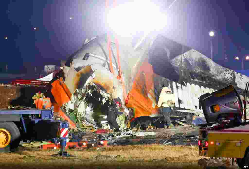 Firefighters and rescue personnel work near the scene where a Jeju Air Boeing 737-800 series aircraft crashed and burst into flames at Muan International Airport, Dec. 29, 2024.&nbsp;