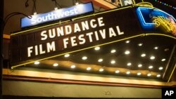 FILE - The Sundance Film Festival sign in lit up on Main Street, Park City, Utah.
