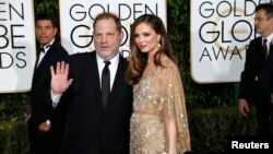 Producer Harvey Weinstein and his wife, fashion designer Georgina Chapman, arrive at the 73rd Golden Globe Awards in Beverly Hills, California