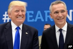 NATO Secretary General Jens Stoltenberg speaks with US President Donald Trump, left, during a summit at the NATO headquarters in Brussels, May 25, 2017.
