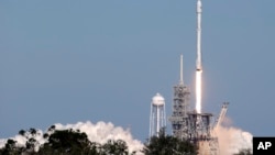 A Falcon 9 SpaceX rocket carrying a communications satellite lifts off from pad 39A at the Kennedy Space Center in Cape Canaveral, Florida, Oct. 30, 2017.