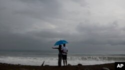 Girls leap as they pose for a photo at a street festival in Gwangju, South Korea.