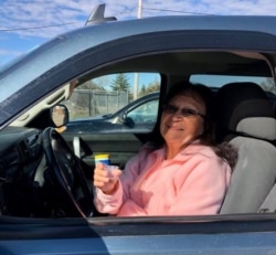 Rosebud Episcopal Mission worshipper Sandra Wilcox receiving communal wine "on the go" before wine was removed from sacrament due to COVID. (Courtesy: Rev. Lauren Stanley)