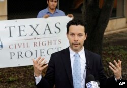 Immigration attorney Efren Olivares, with the Texas Civil Rights Project, answers a question during a news conference outside the Federal Courthouse, June 22, 2018, in McAllen, Texas.