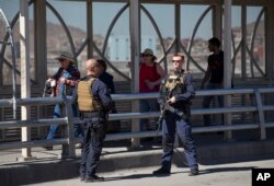 FILE - Pedestrians cross into Juarez, Mexico, as U.S. Customs and Border Protection officers patrol the Paso del Norte Port of Entry in El Paso, Texas, Feb. 16, 2016.