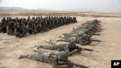 In this Wednesday, Oct. 31, 2018, photo, Afghan National Army (ANA) soldiers carry out an exercise during a live firing at the Afghan Military Academy in Kabul, Afghanistan. The Taliban welcomed the news of the U.S. plan to withdraw half its troops…