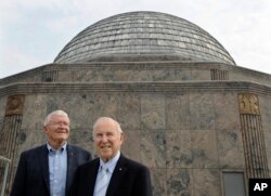 FILE - Apollo 13 crew members Commander Captain James A. Lovell, Jr., right, and Lunar Module Pilot Fred W. Haise pose for a photo during a 40th Anniversary reunion of the moon mission at the Adler Planetarium, April 12, 2010, in Chicago.