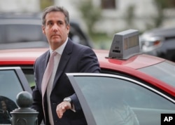 Michael Cohen, President Donald Trump's personal attorney, steps out of a cab during his arrival on Capitol Hill in Washington, Sept. 19, 2017.