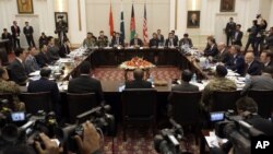 FILE - Delegations from Afghanistan, Pakistan, China and the United States discuss a roadmap for ending the war with the Taliban, at the Presidential Palace in Kabul, Afghanistan, Jan. 18, 2016.