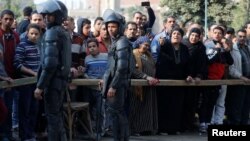 People gather at the site of attack on a church in the Helwan district south of Cairo, Egypt, Dec. 29, 2017.