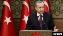 Turkish President Tayyip Erdogan makes a speech during his meeting with local leaders at the Presidential Palace in Ankara, Turkey, Dec. 1, 2016. On Sunday, Dec. 4, 2016, Erdogan asked Turkish patriots to change their dollars or euros into liras or gold to help ease the current currency crisis. 