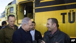Israel's Prime Minister Benjamin Netanyahu shakes hands with the head of a Turkish delegation of fire fighters and firefighting planes that arrived at Ramat David air force base in northern Israel to help fight a wildfire, 03 Dec 2010